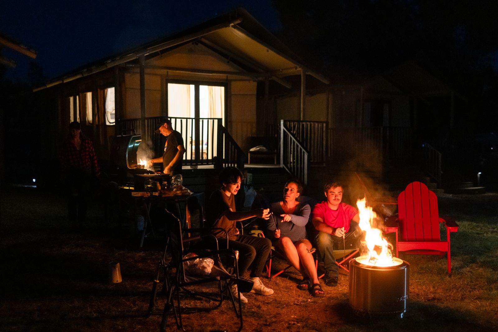 Family gathered around a firepit at Outdoorsy Bayfield